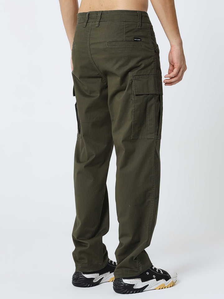 Person wearing olive green cargo pants on a white background