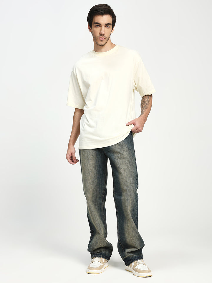 Man wearing a white t-shirt and blue jeans on a white background