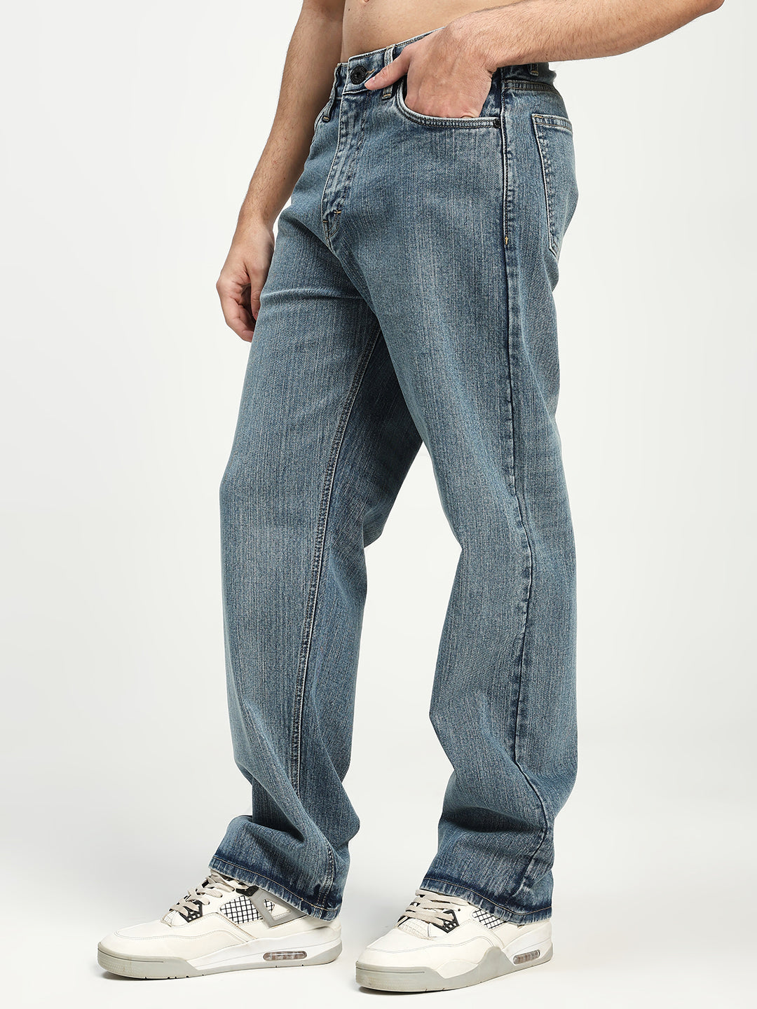 man wearing blue jeans on a white background