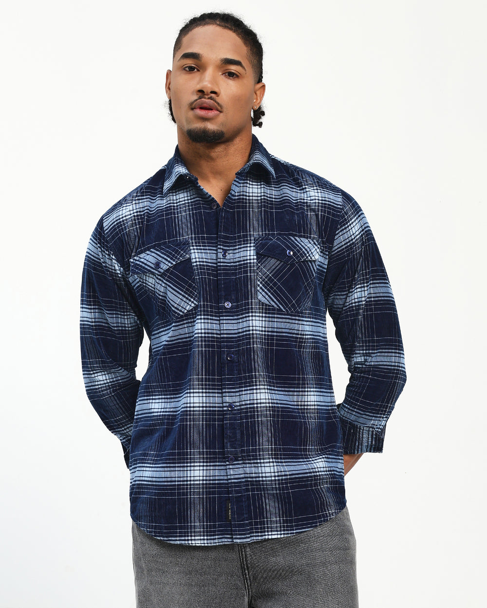Man wearing a blue plaid shirt on a white background