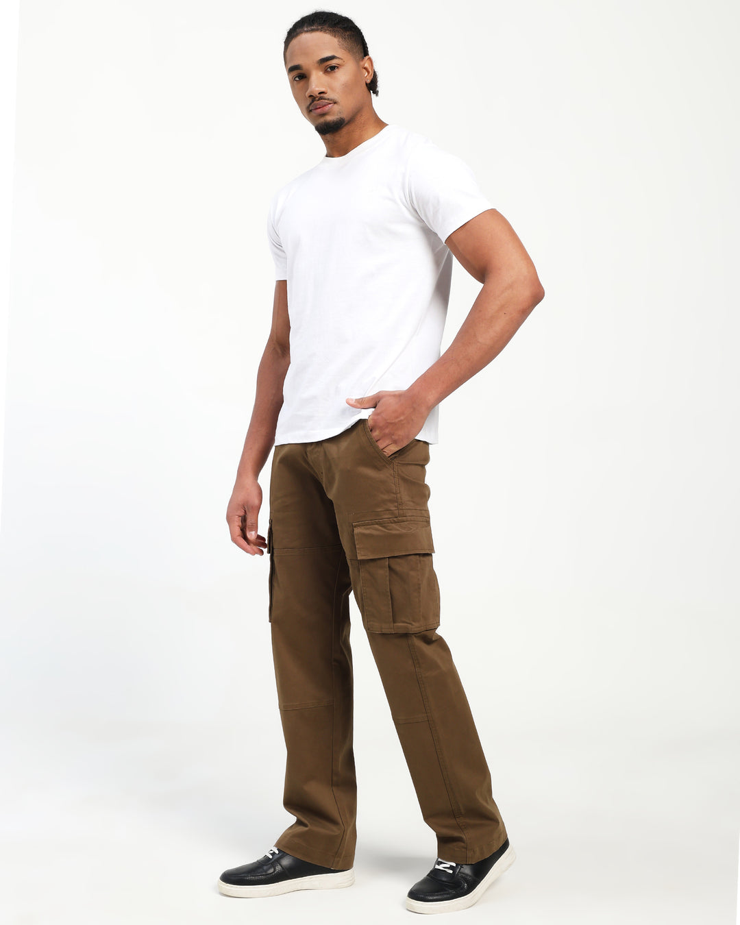 Man wearing a white t-shirt and brown cargo pants on a white background
