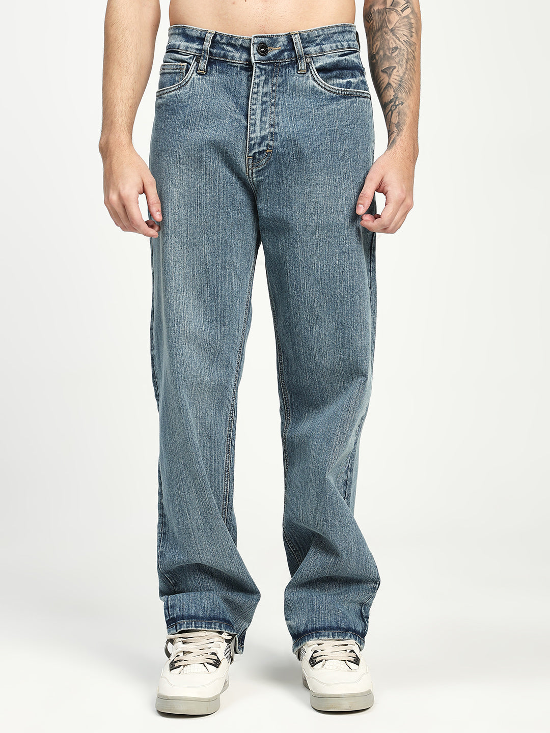 man wearing light blue jeans on a white background