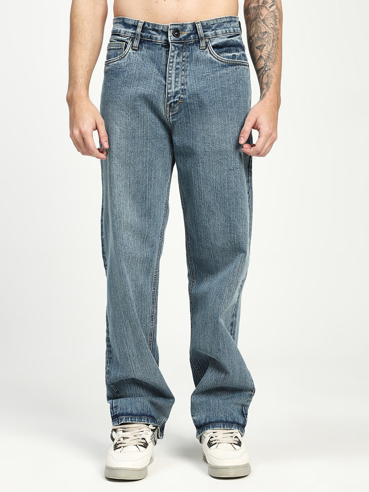 man wearing light blue jeans on a white background