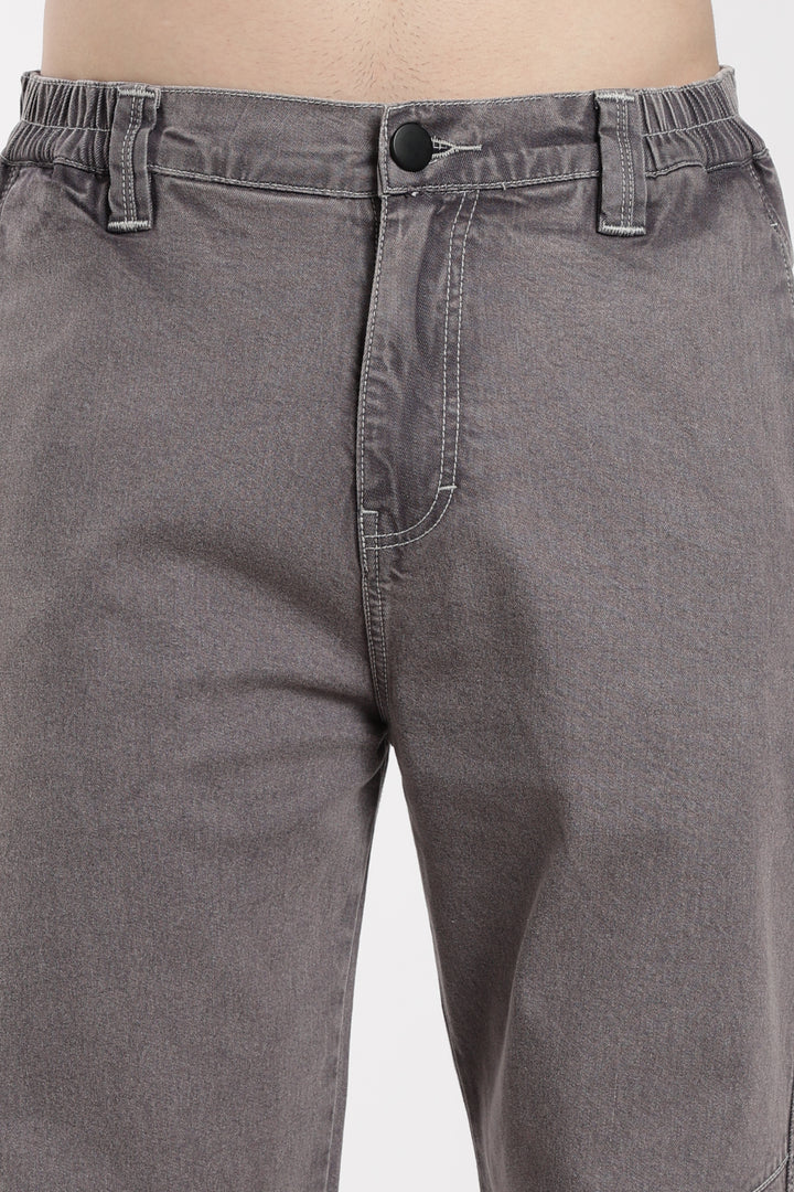 Close-up of gray jogger on a plain background
