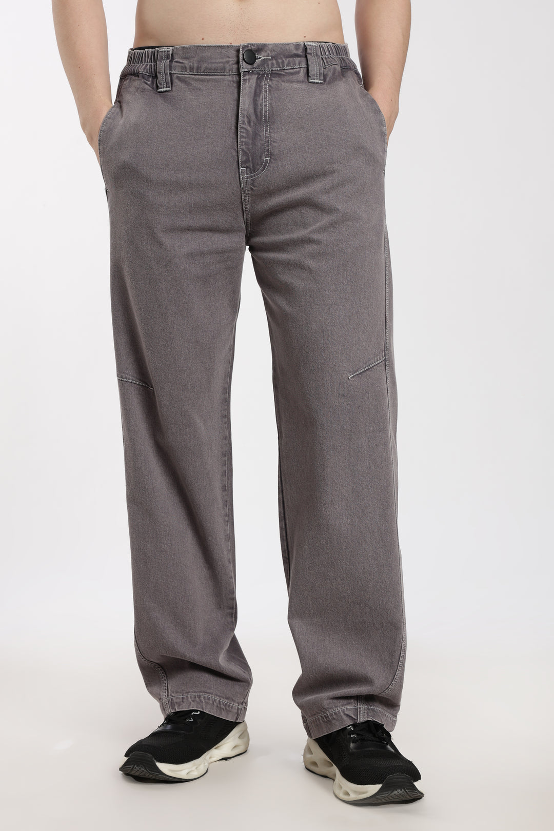 man wearing gray jogger on a white background