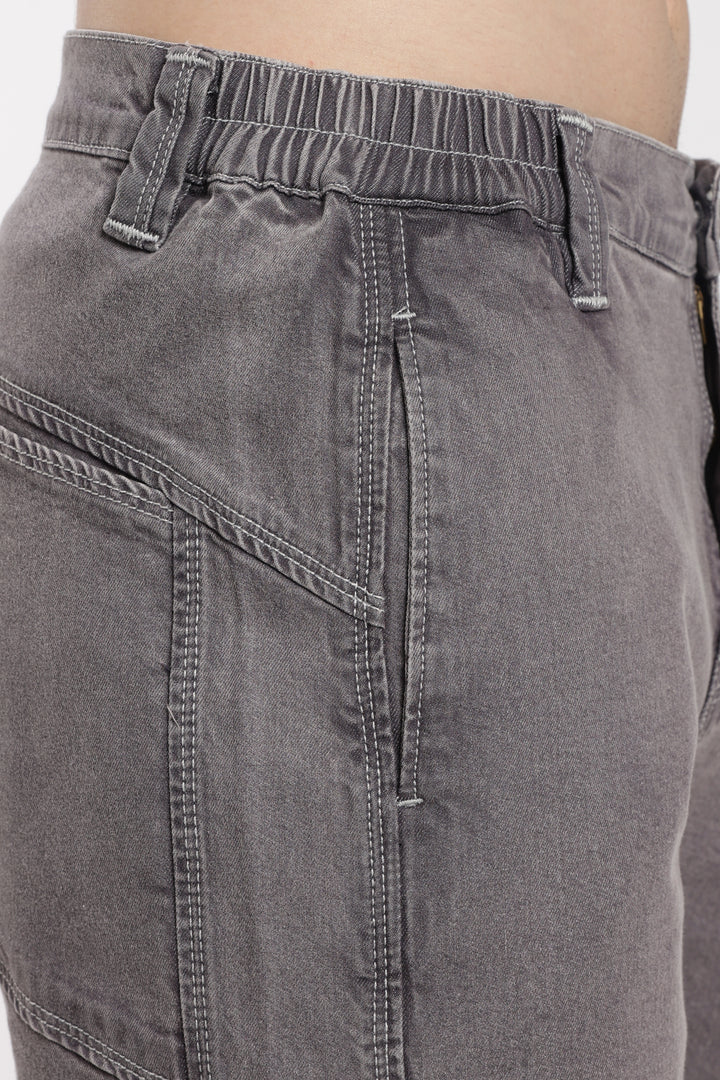 Close-up of gray jogger with a plain background
