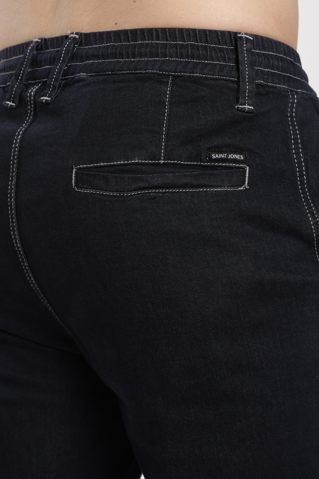 blue jogger with a brand sint jones on the pocket against a white background