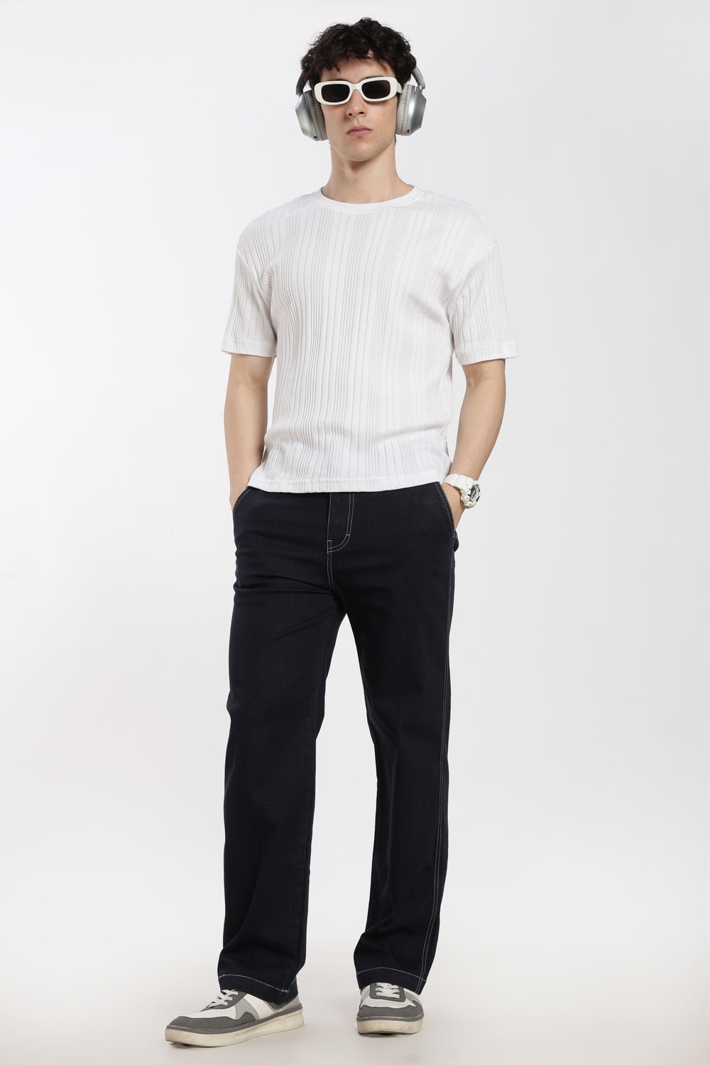 man wearing a white t-shirt and blue jogger on a white background