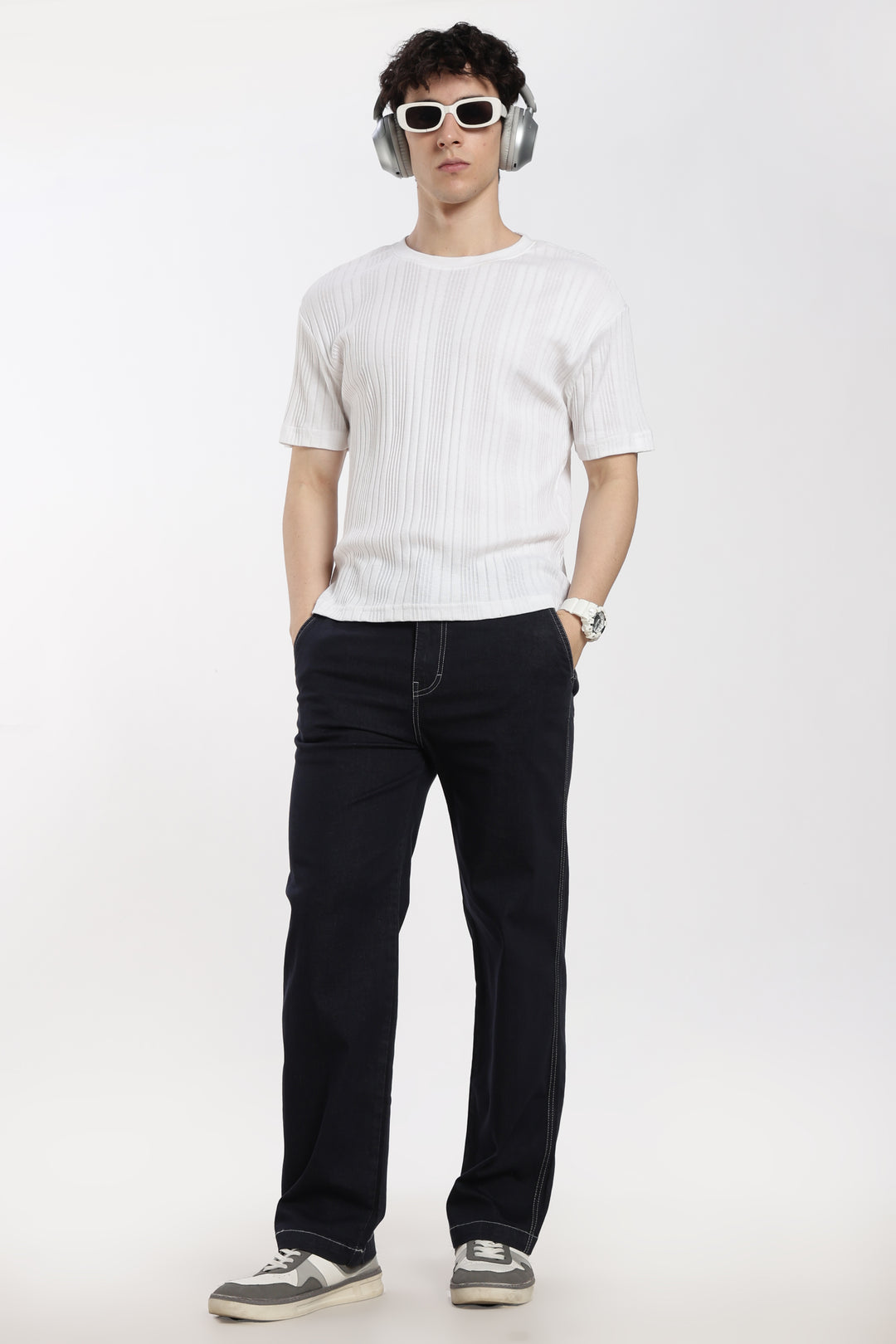 man wearing a white t-shirt and blue jogger on a white background
