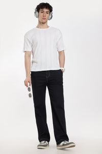man wearing a white t-shirt, blue jogger, and headphones on a white background