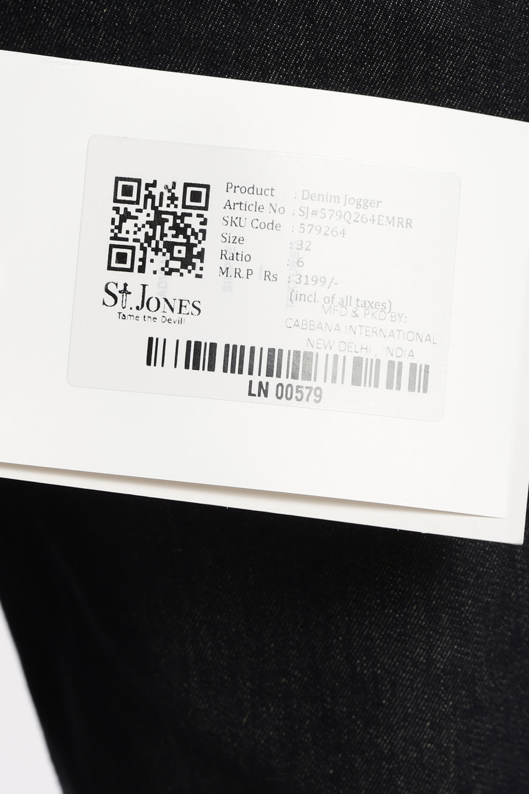 Close-up of a label on a black garment with 'St. Jones' branding.