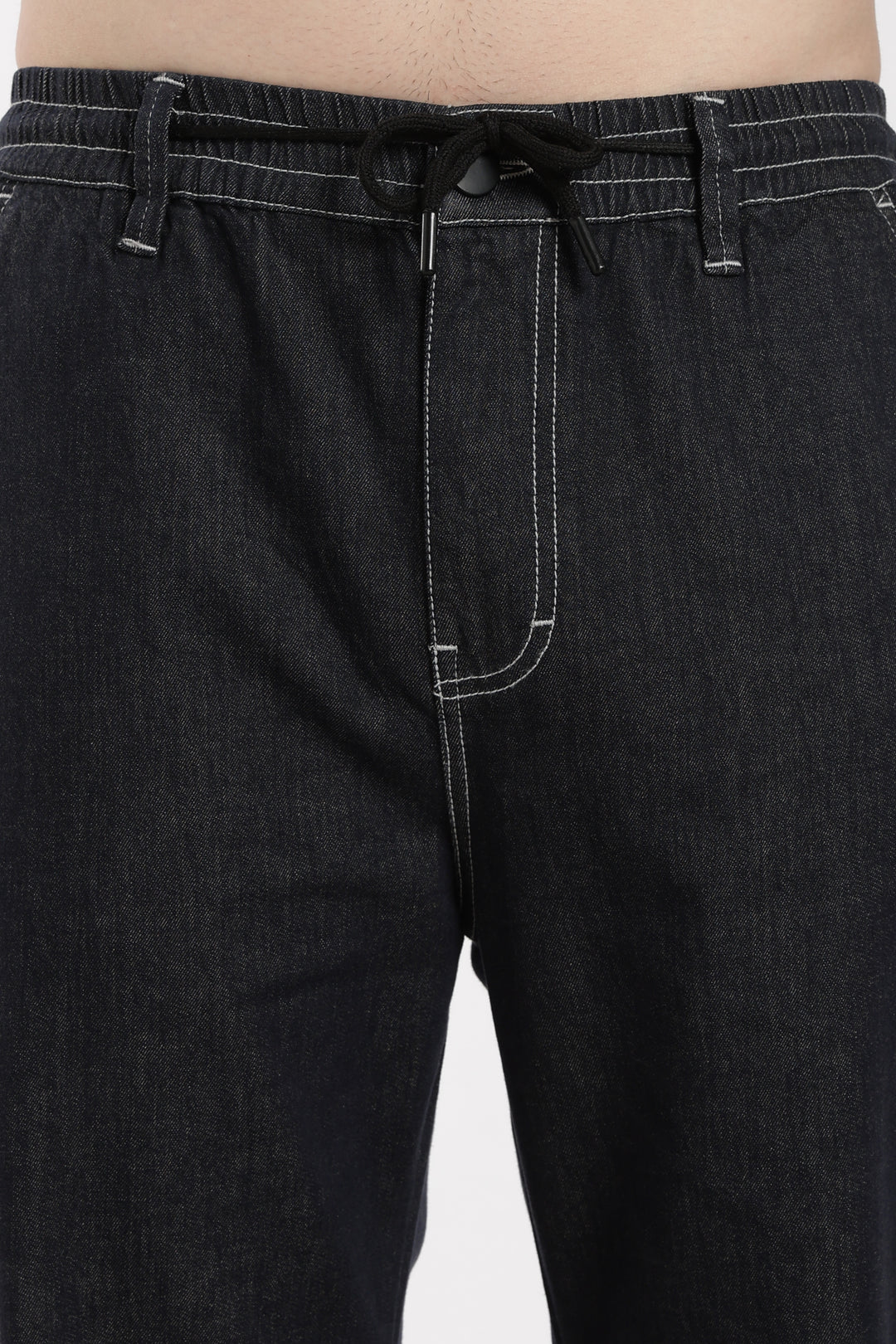 dark wash denim jogger pants with a drawstring waist on a white background