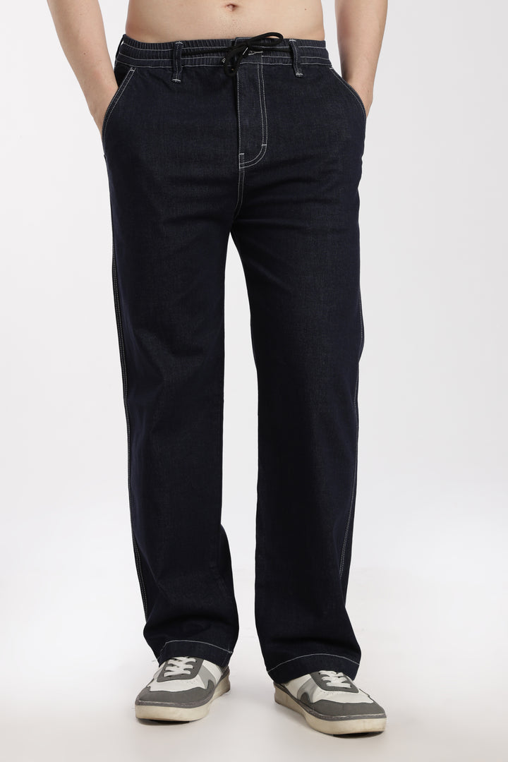 man wearing navy blue denim jogger pant on a white background