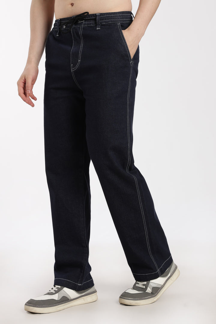 man wearing navy blue denim jogger pant on a white background