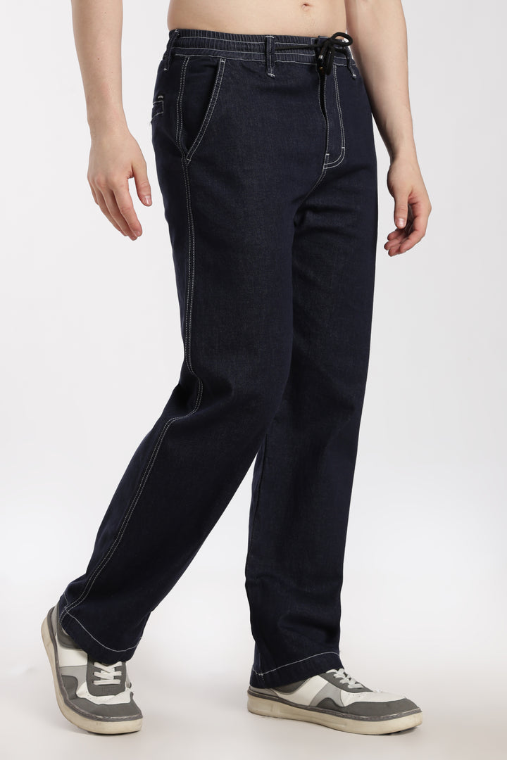 man wearing navy blue denim jogger pant on a white background