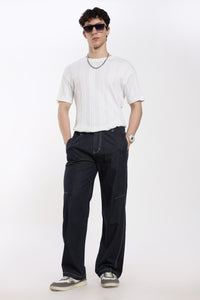 Man wearing a white t-shirt, blue denim jogger, and sunglasses on a white background