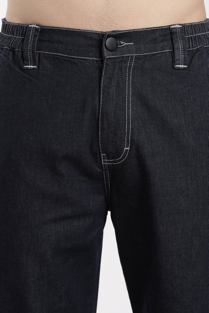 Close-up of blue denim jogger on a white background