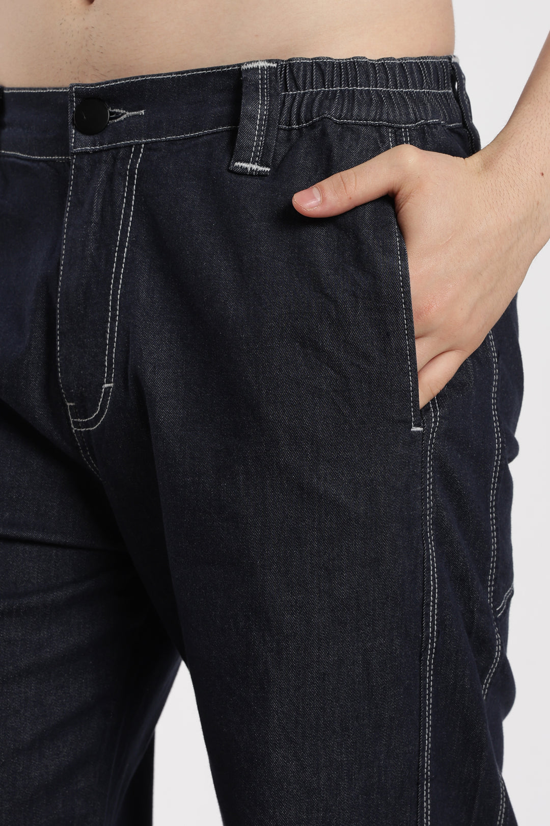 blue denim jogger with a hand in the pocket on a white background