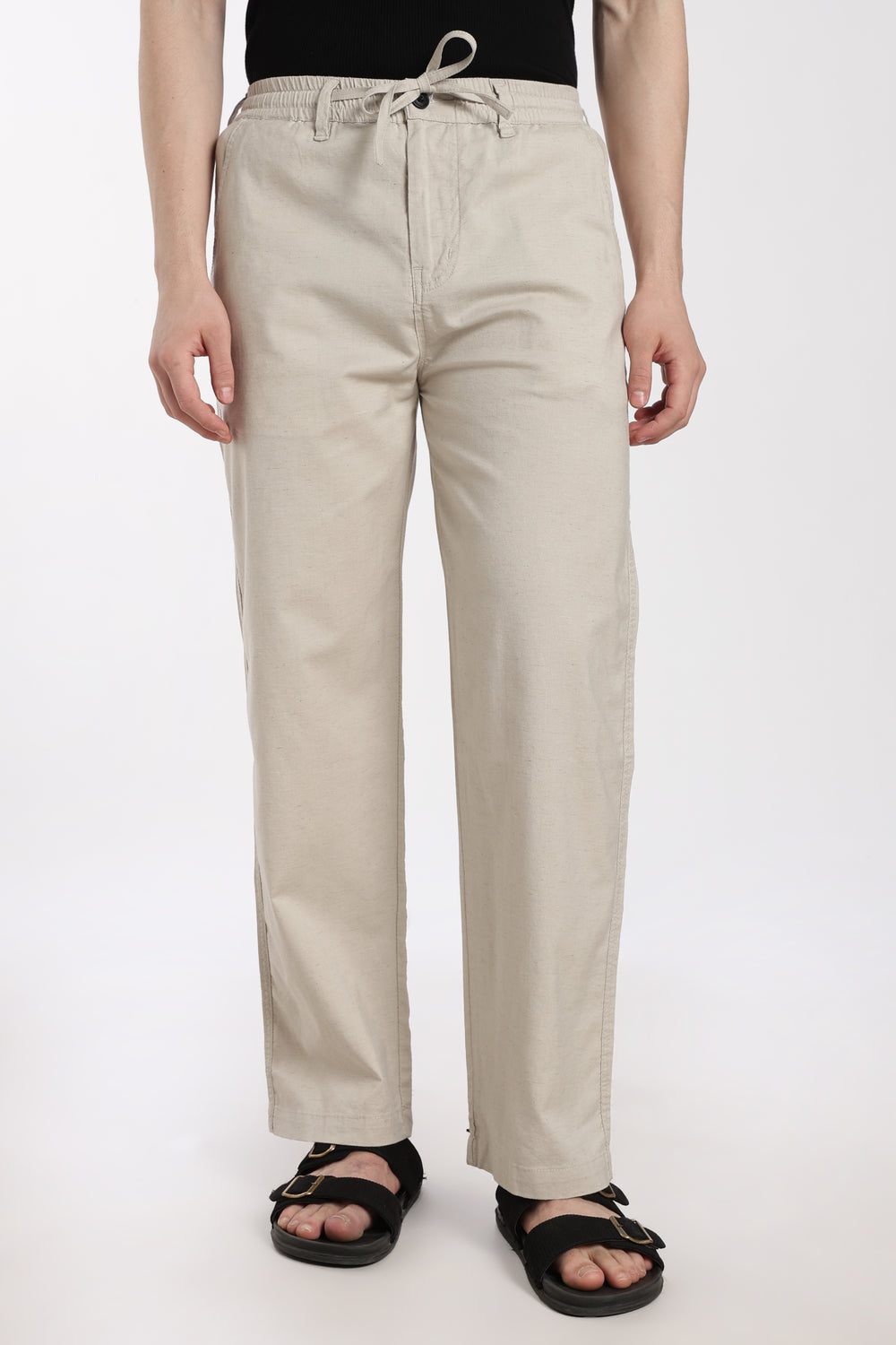 desert sand linen pants worn by a man on a white background