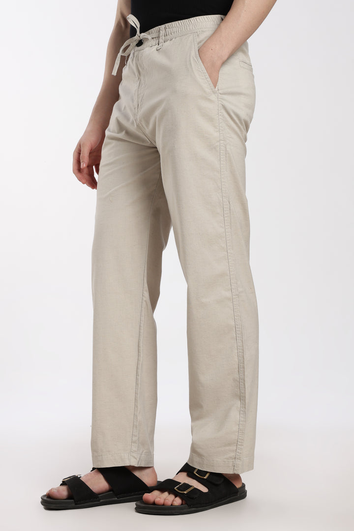 desert sand linen pants worn by a man on a white background