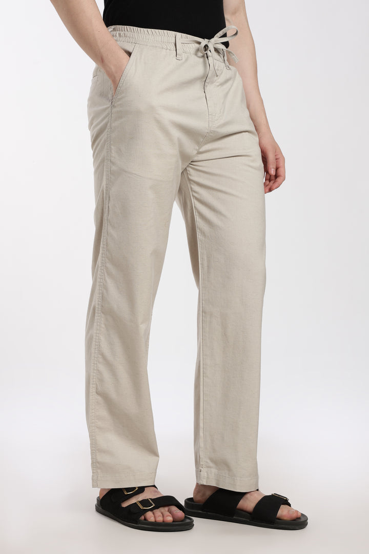 desert sand linen pants worn by a man on a white background