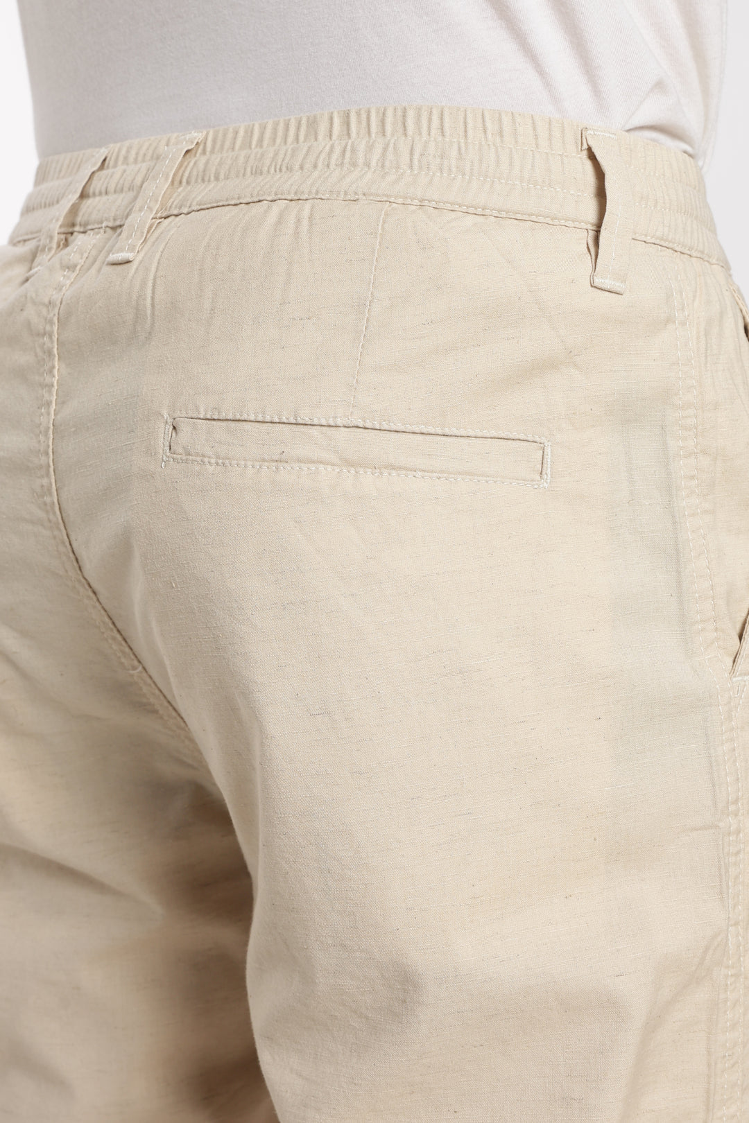 Beige linen pants with a white background
