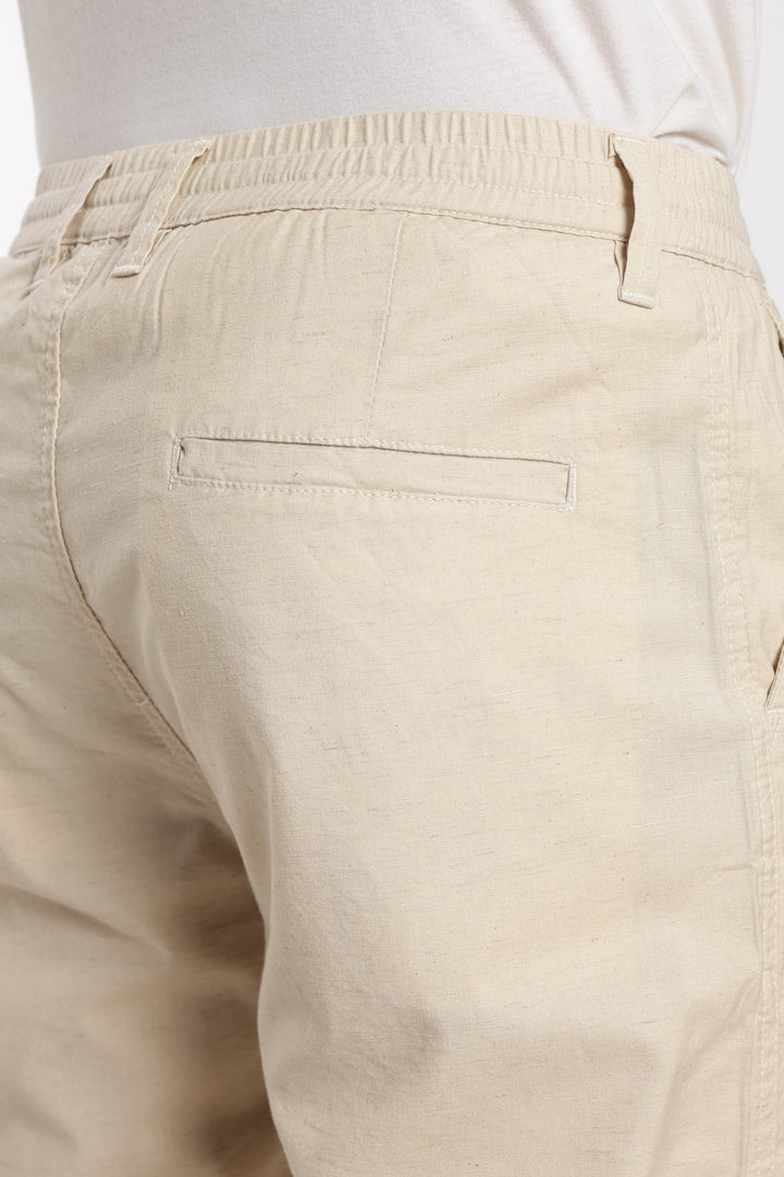 Beige linen pants with a white background