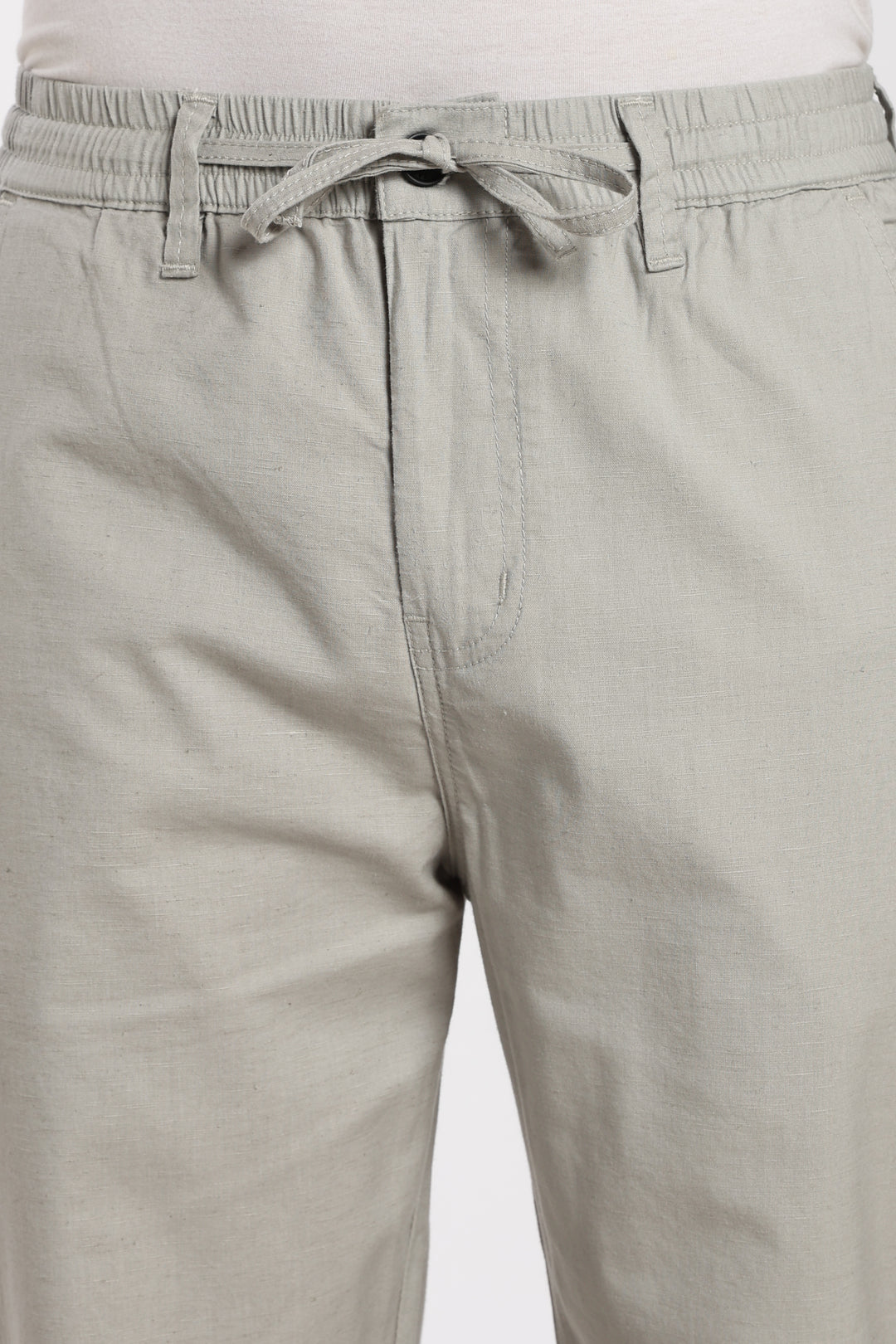 Close-up of linen pants with a drawstring on a white background
