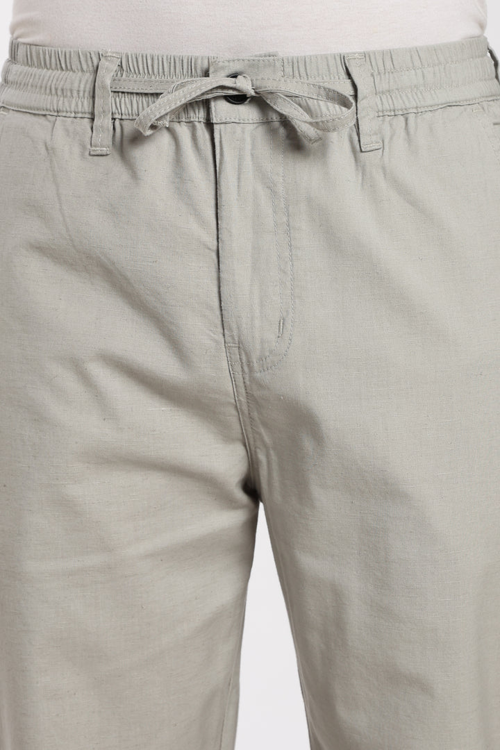 Close-up of linen pants with a drawstring on a white background