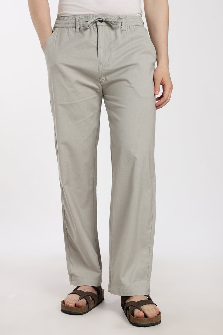 Light gray pants worn by a man on a white background