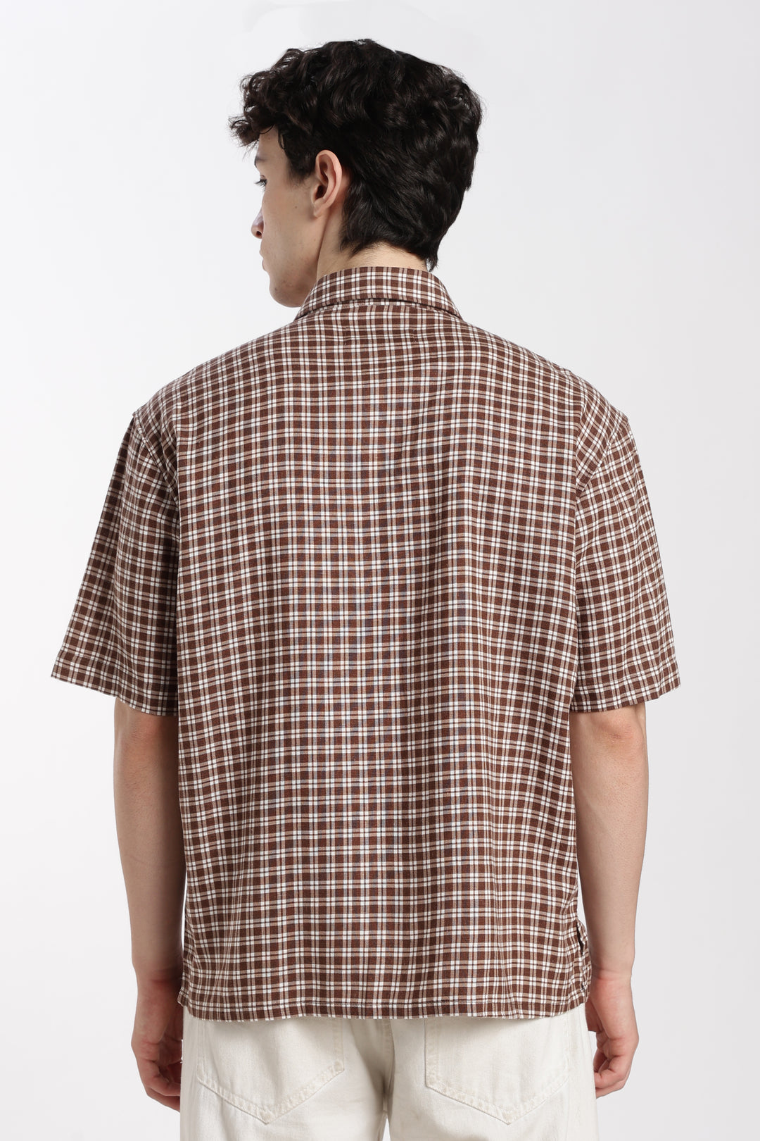 man wearing a brown checkered half sleeve shirt on a white background