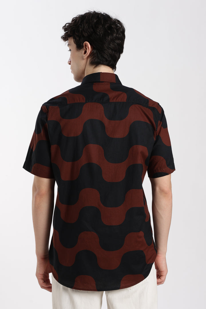 man wearing a black and red patterned half sleeve shirt on a white background