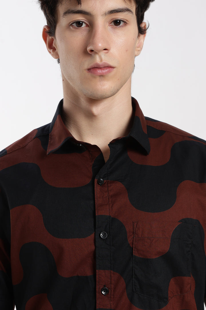 Man wearing a red and black camouflage half sleeve shirt on a white background