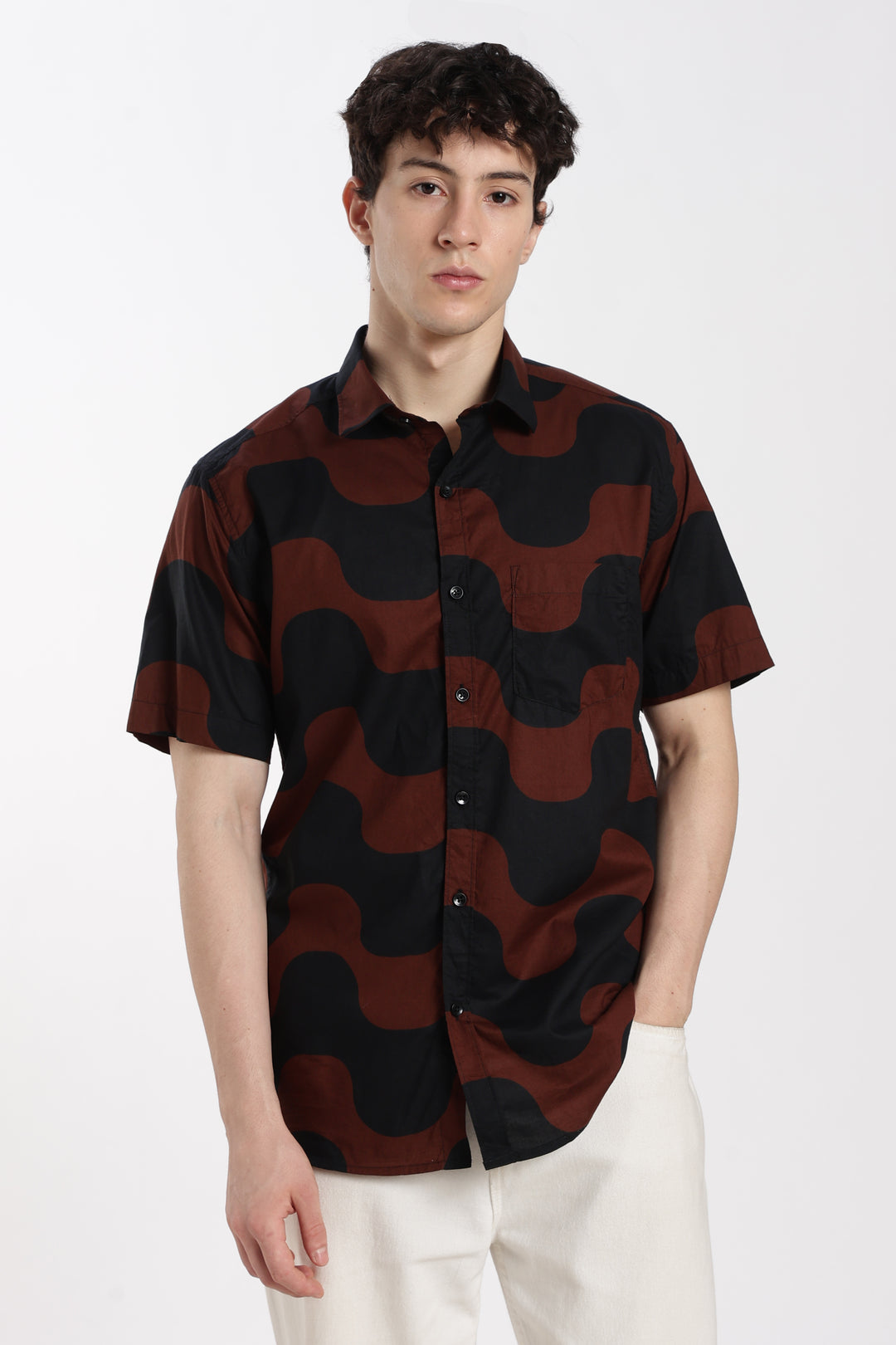 Person wearing a black and red patterned half sleeve shirt on a white background