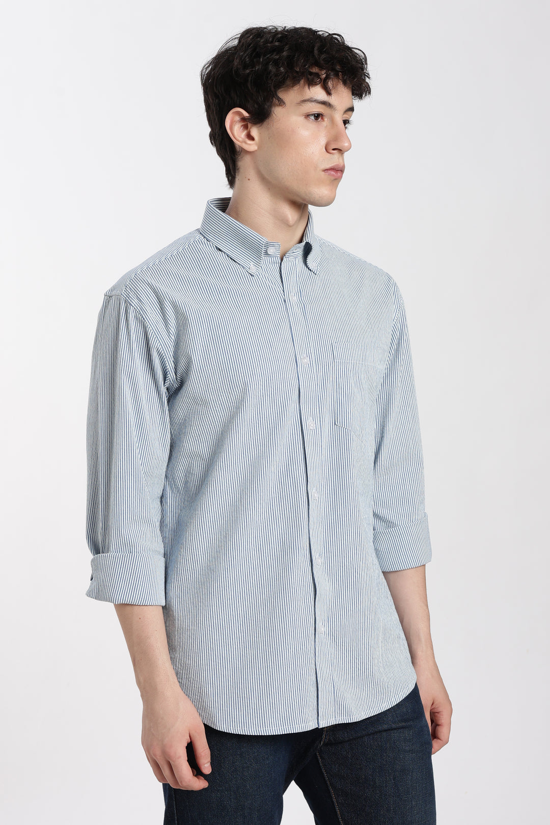 man wearing a blue striped linen shirt on a white background