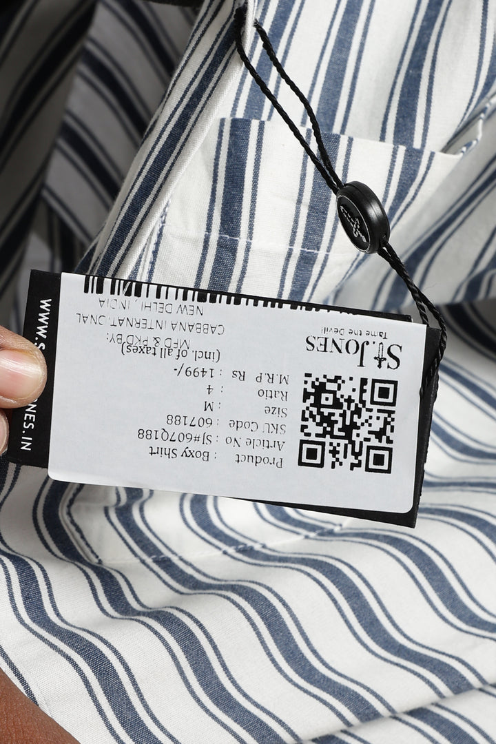 Close-up of a clothing tag with a QR code on a striped fabric background