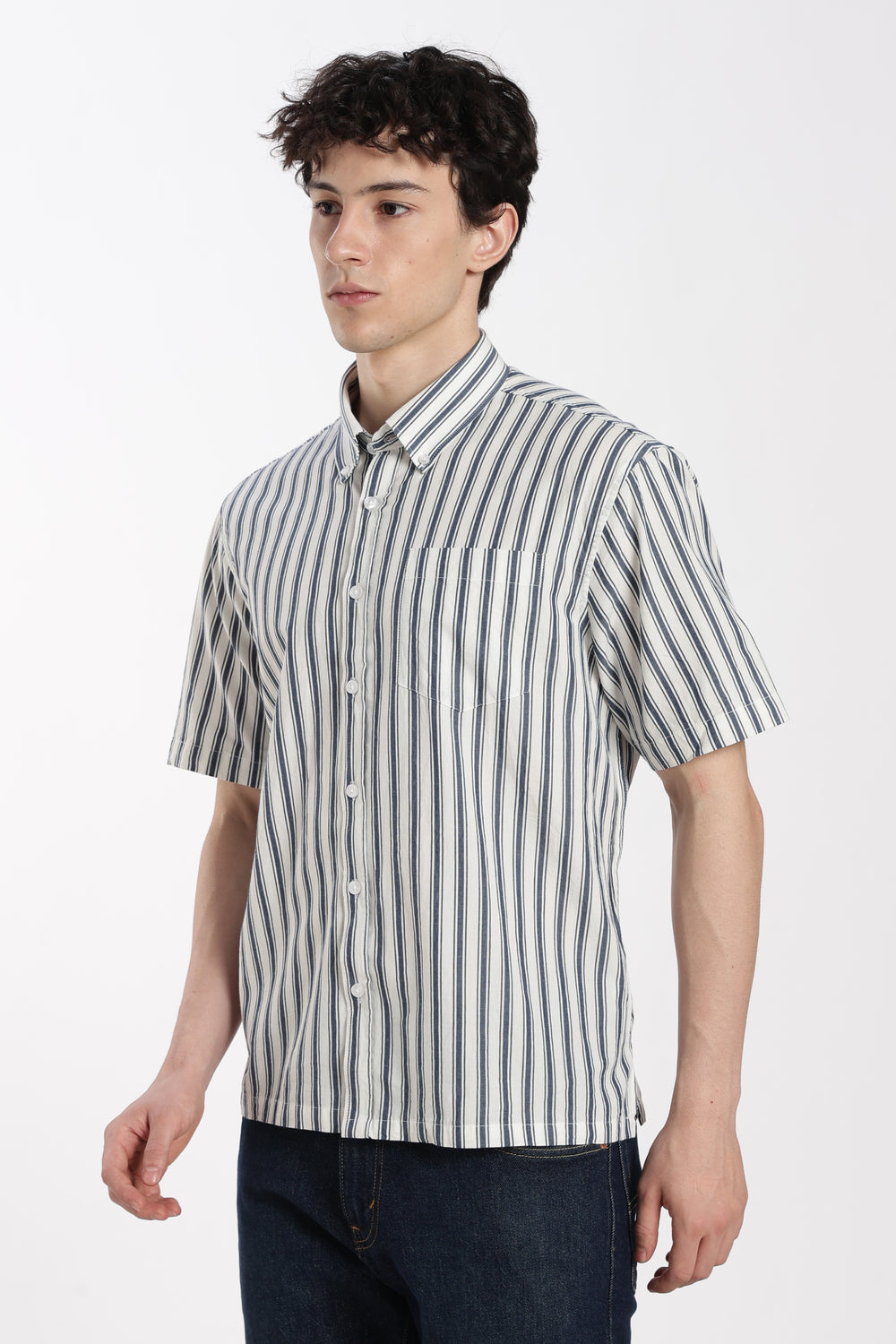 Man wearing a striped half sleeve shirt on a white background