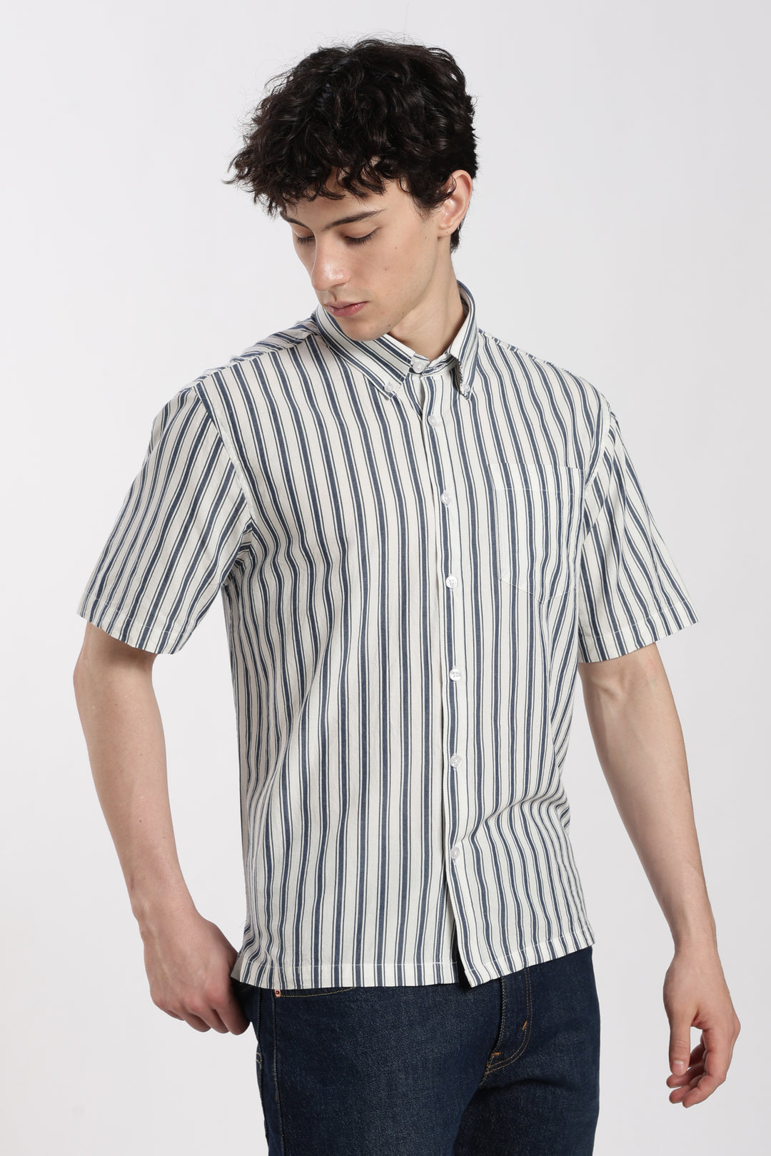 man wearing a black and white striped half sleeve shirt on a white background