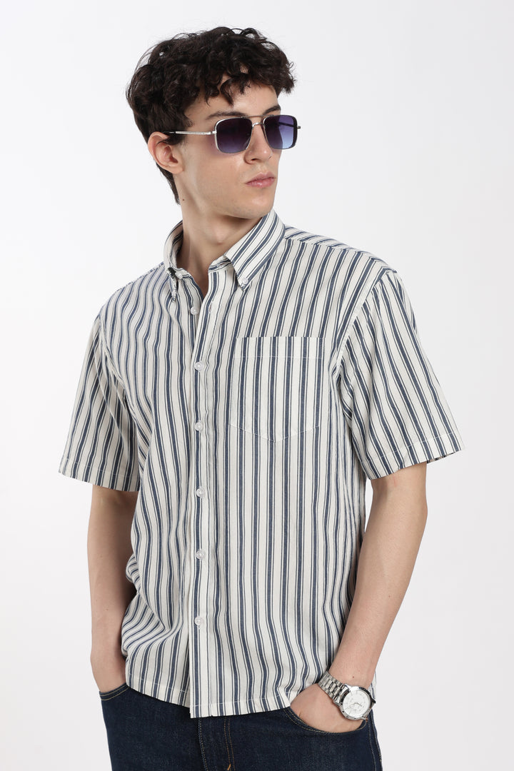 man wearing a striped half sleeve shirt and sunglasses on a white background