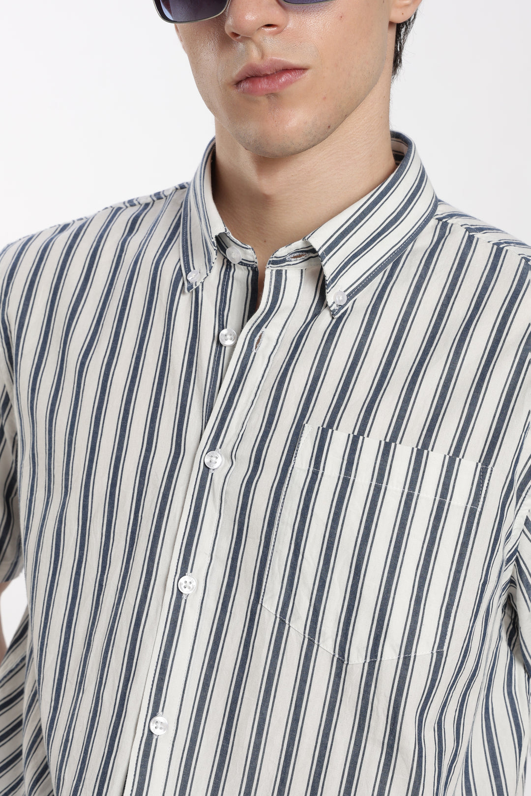 Man wearing a striped half sleeve shirt with a plain background