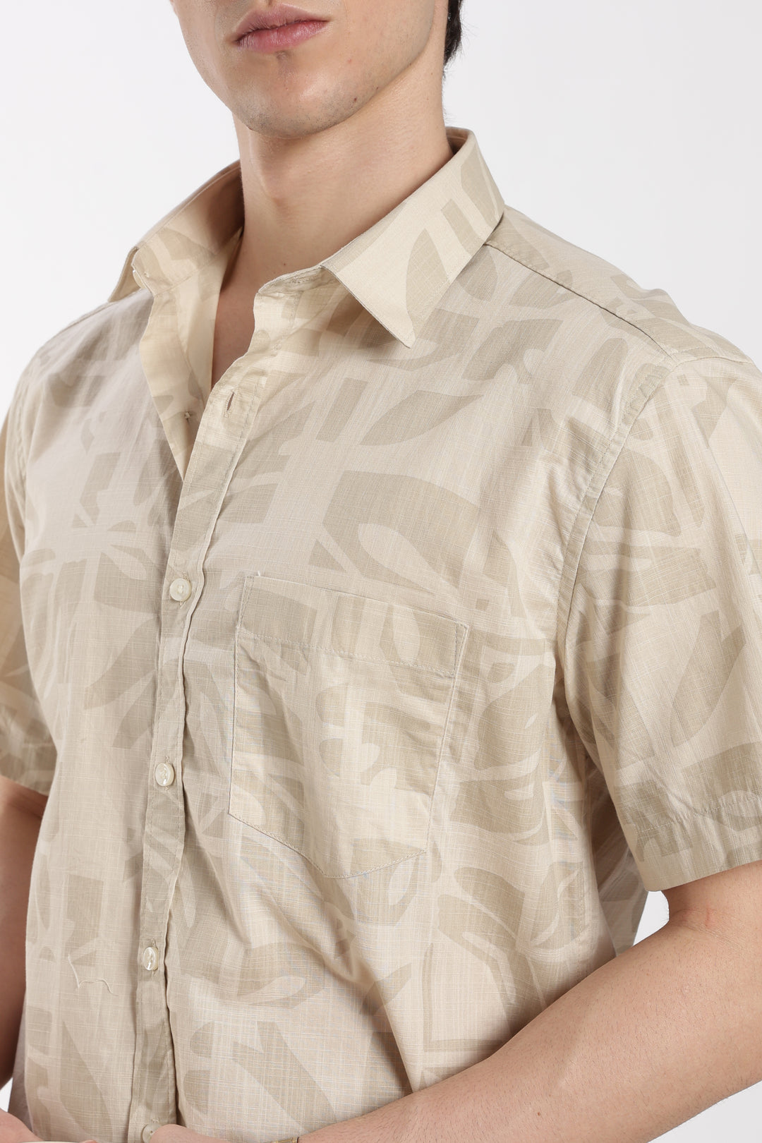 Beige patterned half sleeve shirt worn by a man on a white background