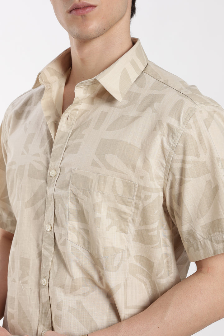 Beige patterned half sleeve shirt worn by a man on a white background