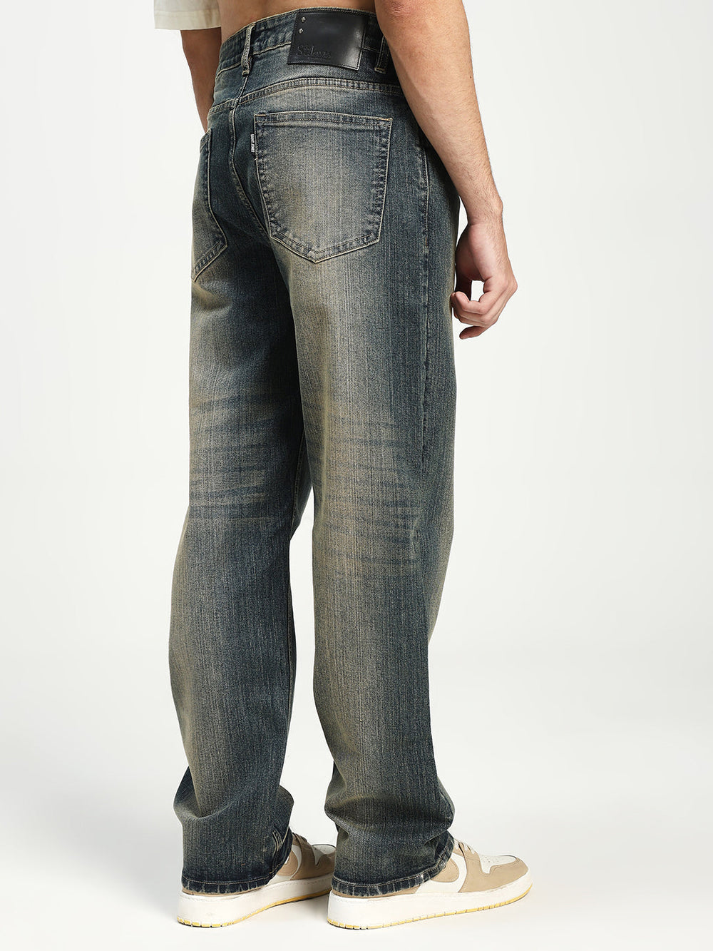man wearing blue jeans on a white background
