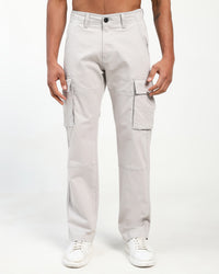man wearing light gray cargo pants on a white background