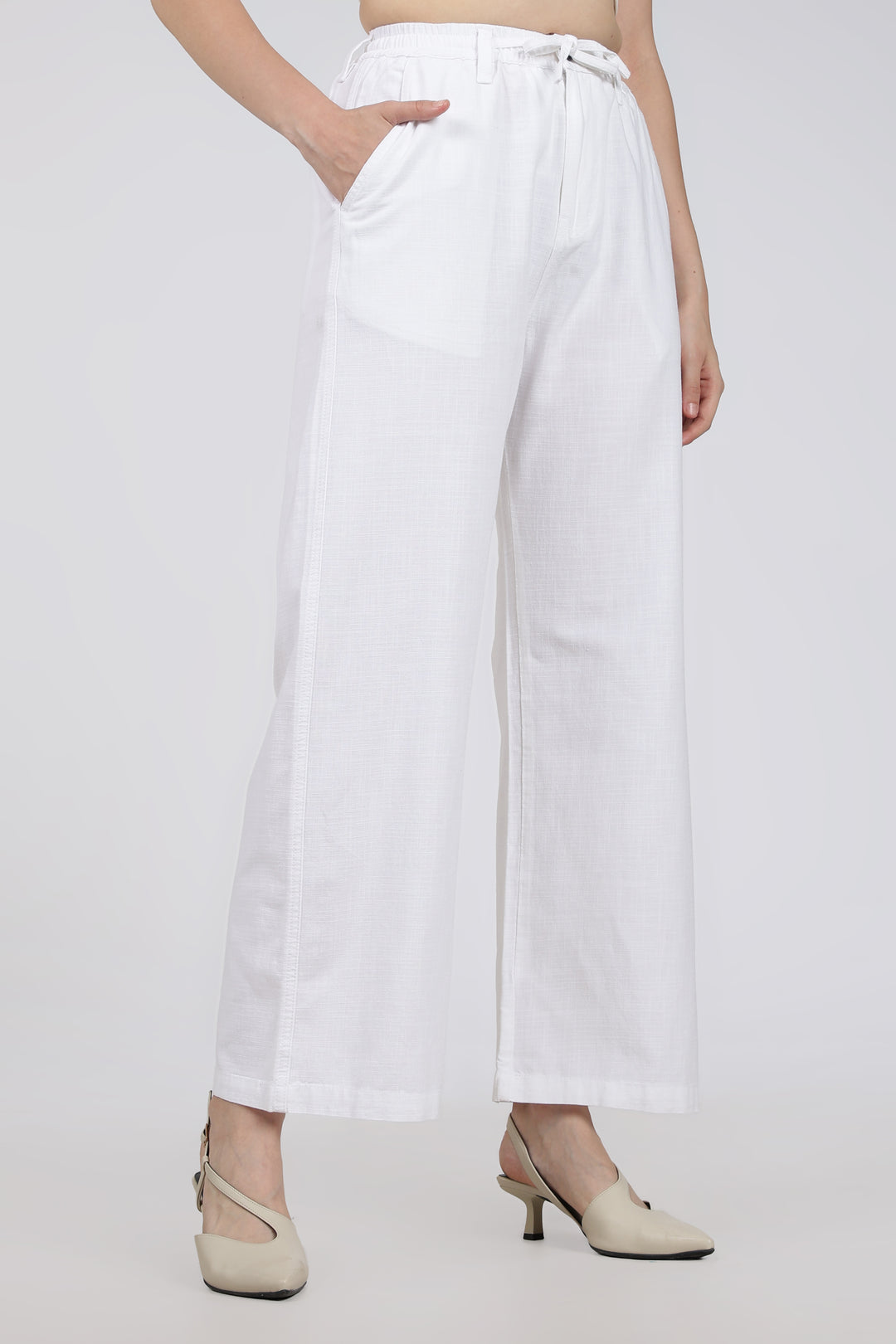 White wide-leg pants worn by a woman on a white background