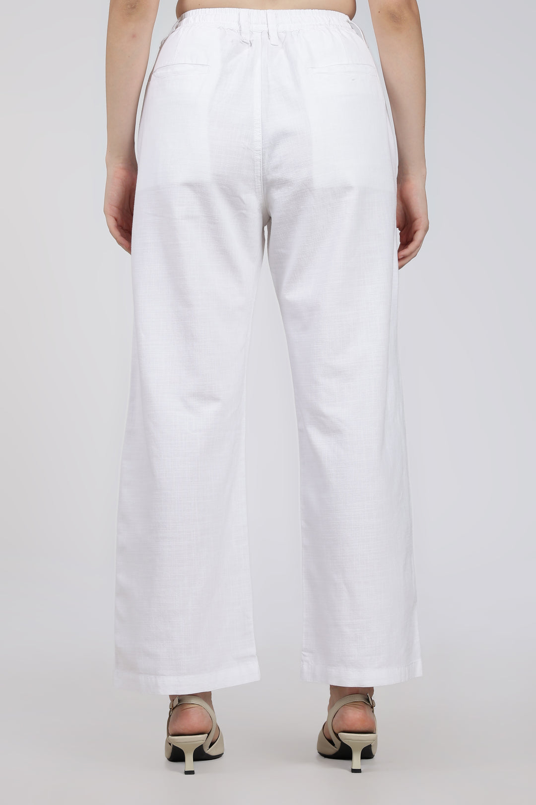 White pants worn by a woman on a white background
