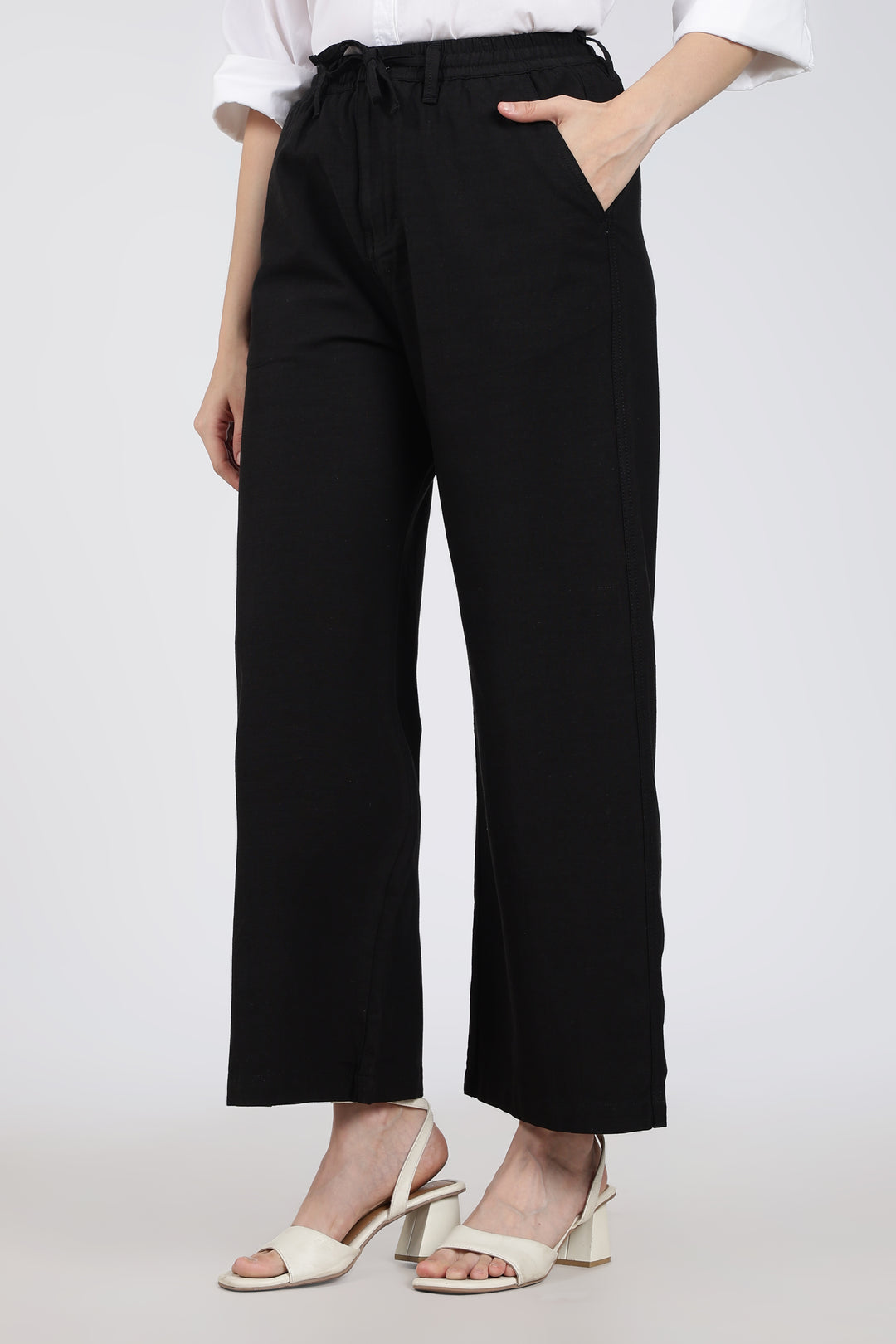 woman wearing black pants with a white background