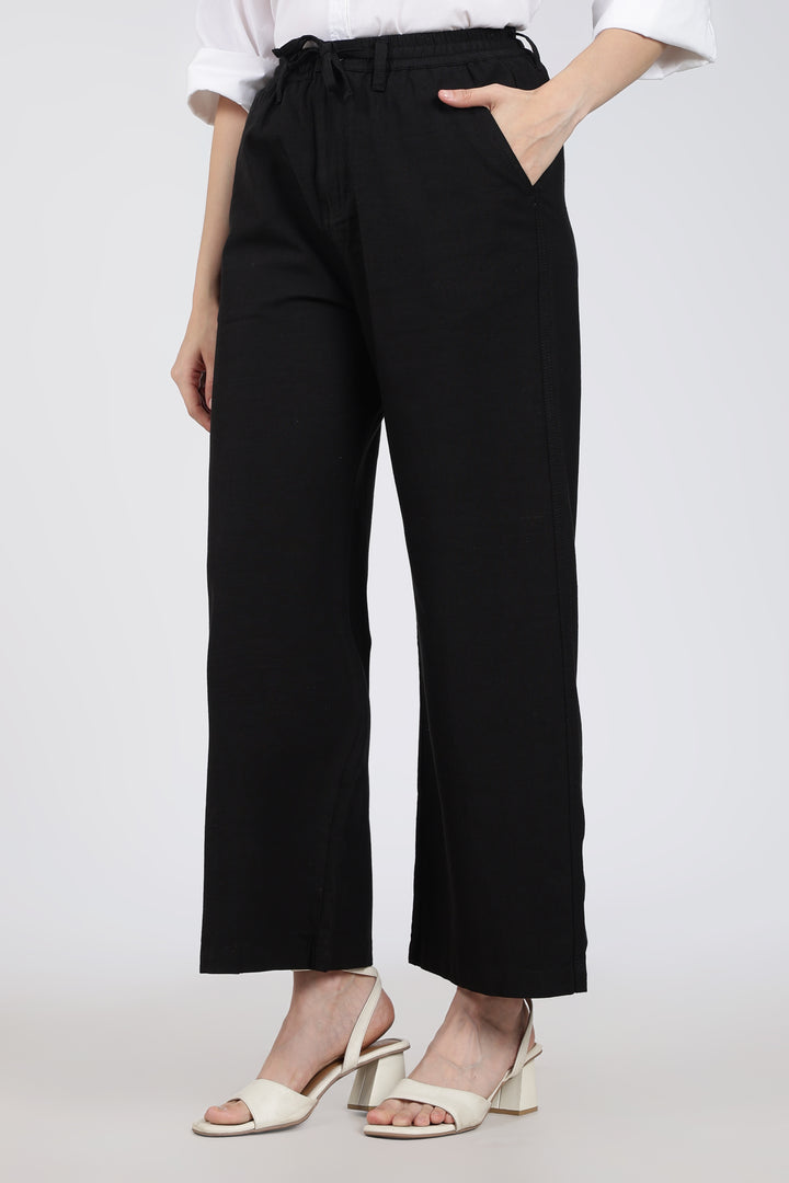 woman wearing black pants with a white background