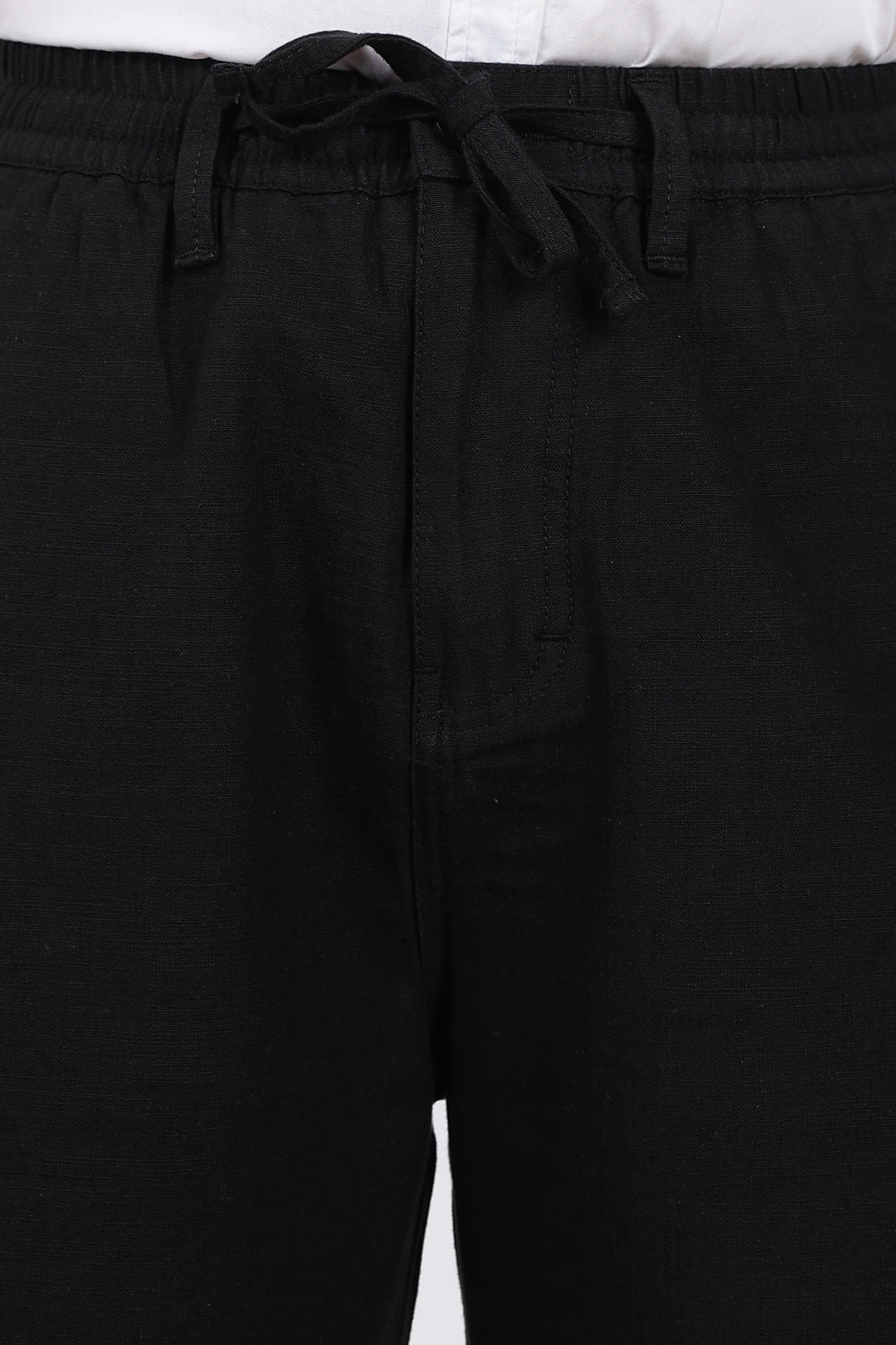 Black pants with a tie waist on a white background