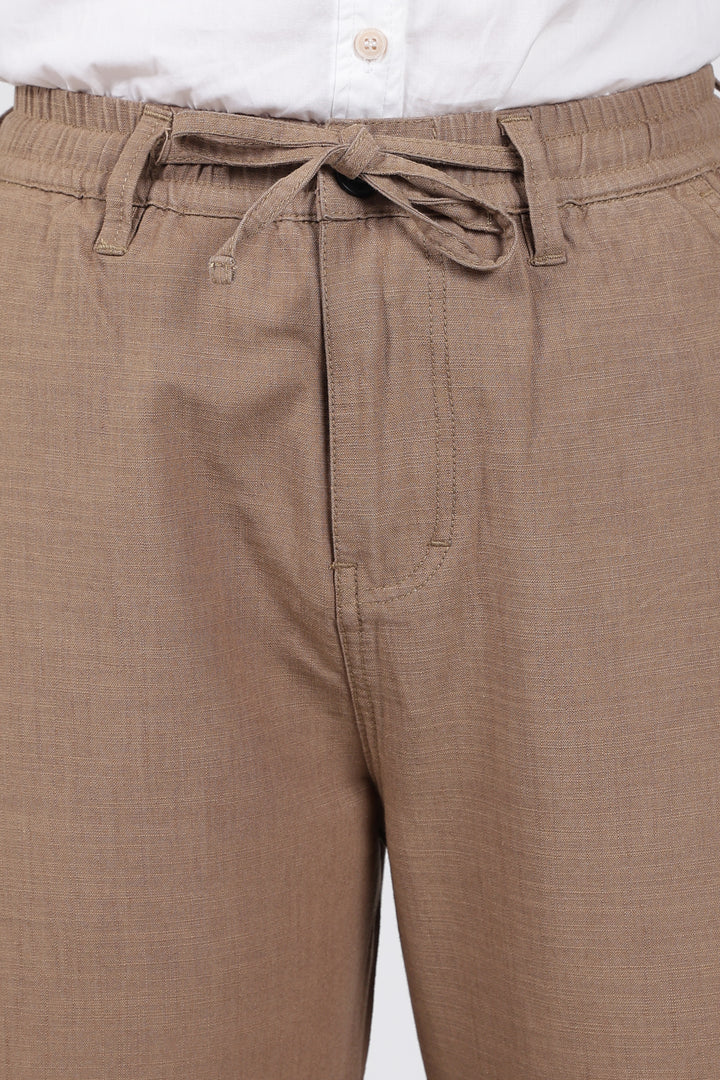 Brown pants with a tie waist on a white background